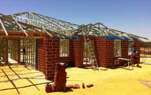 This home has the frame up and the front facade bricked in.